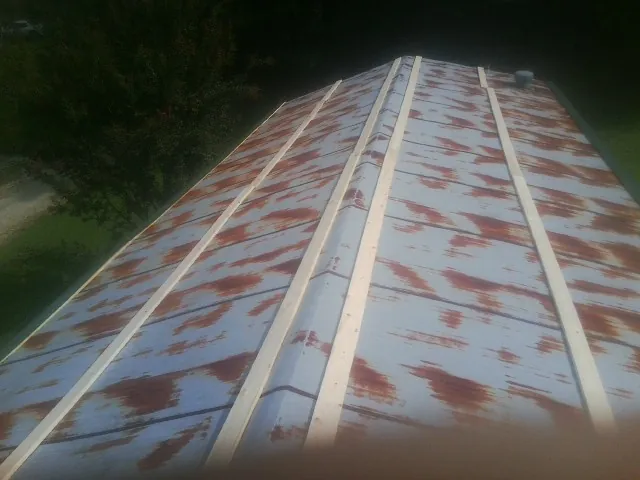 Rusted metal roof panels with new wood purlins before replacement — Storm Damage Roof Repair in Altavista by Roofing Brothers