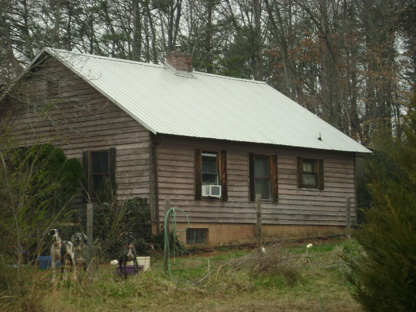 White metal roof on an old wood sided farmhouse, from a Metal Roof Installation job in Altavista